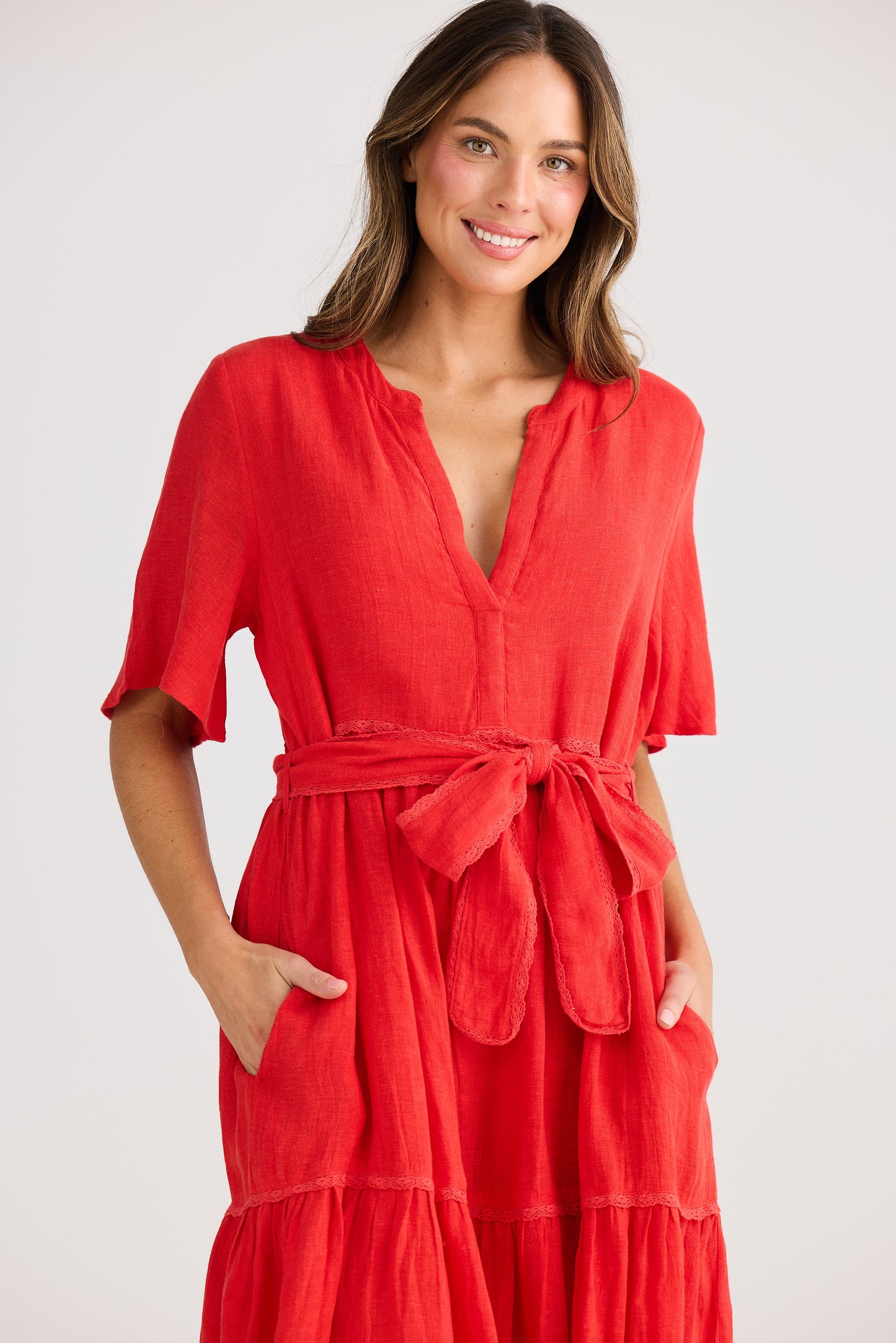 Woman wearing a red dress with a white background