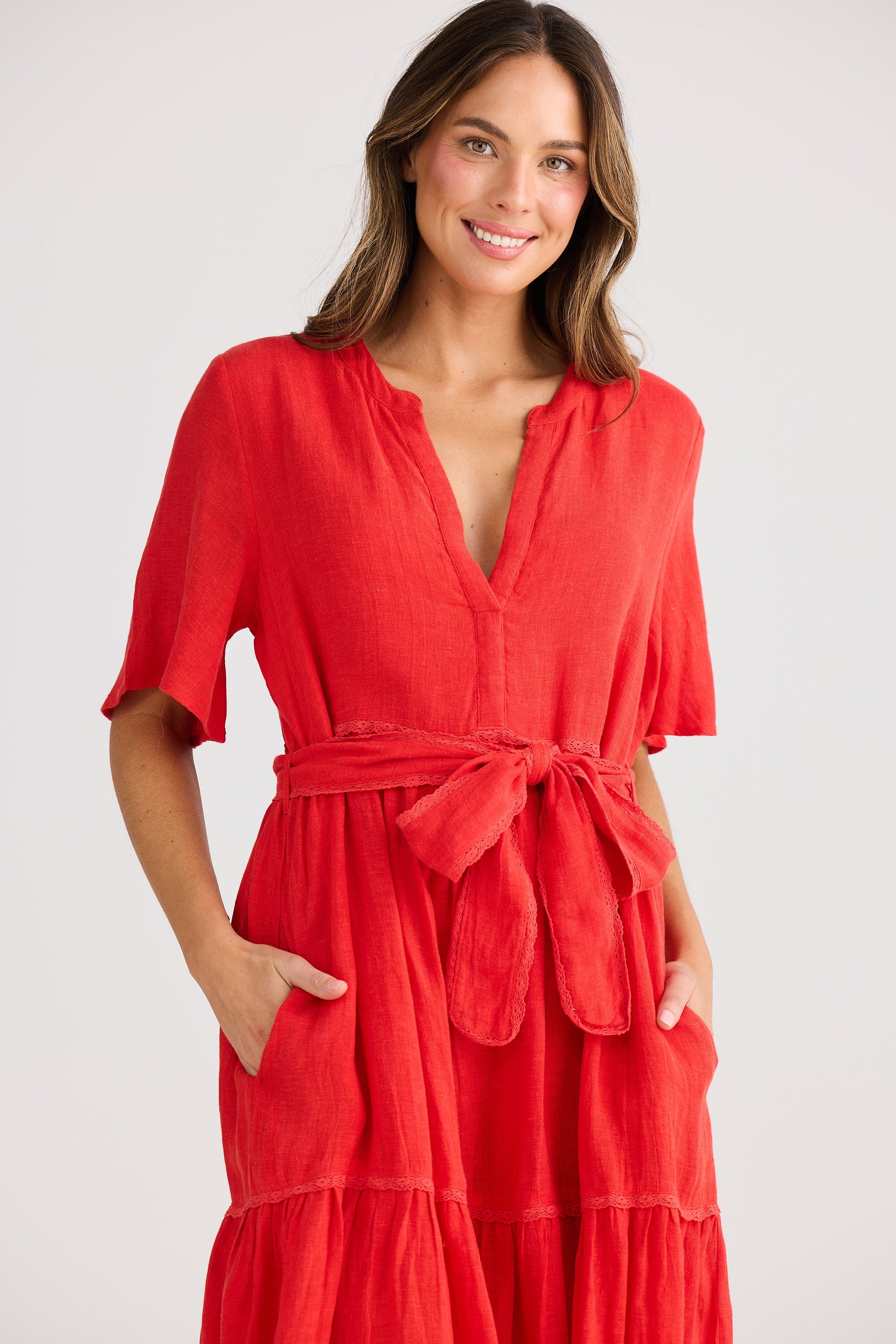 Woman wearing a red dress with a white background