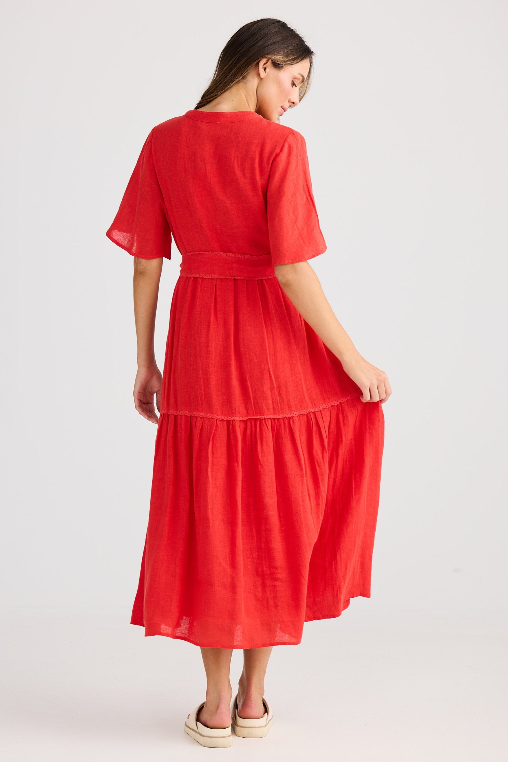 Woman wearing a red dress on a white background