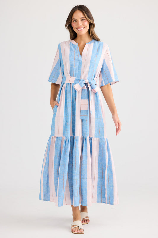 Woman wearing a blue and white striped dress on a white background