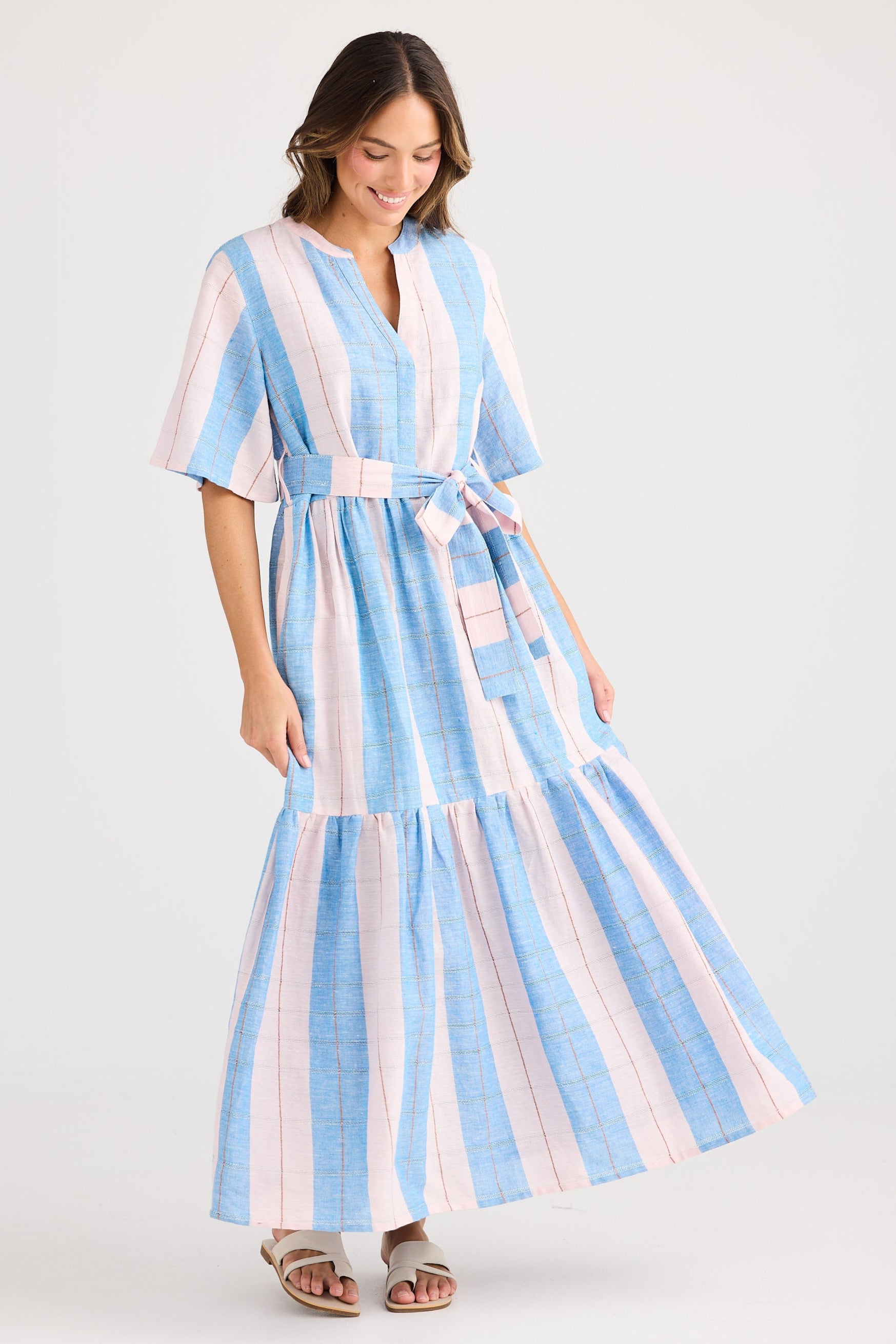 Woman wearing a striped dress with a white background