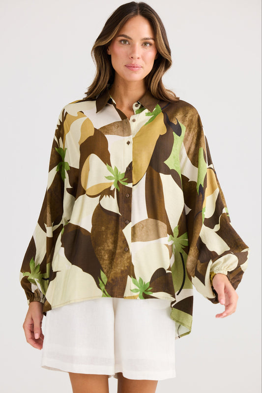Woman wearing a patterned shirt with a white background