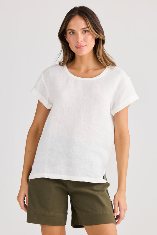 Woman wearing a white t-shirt and green shorts on a plain background