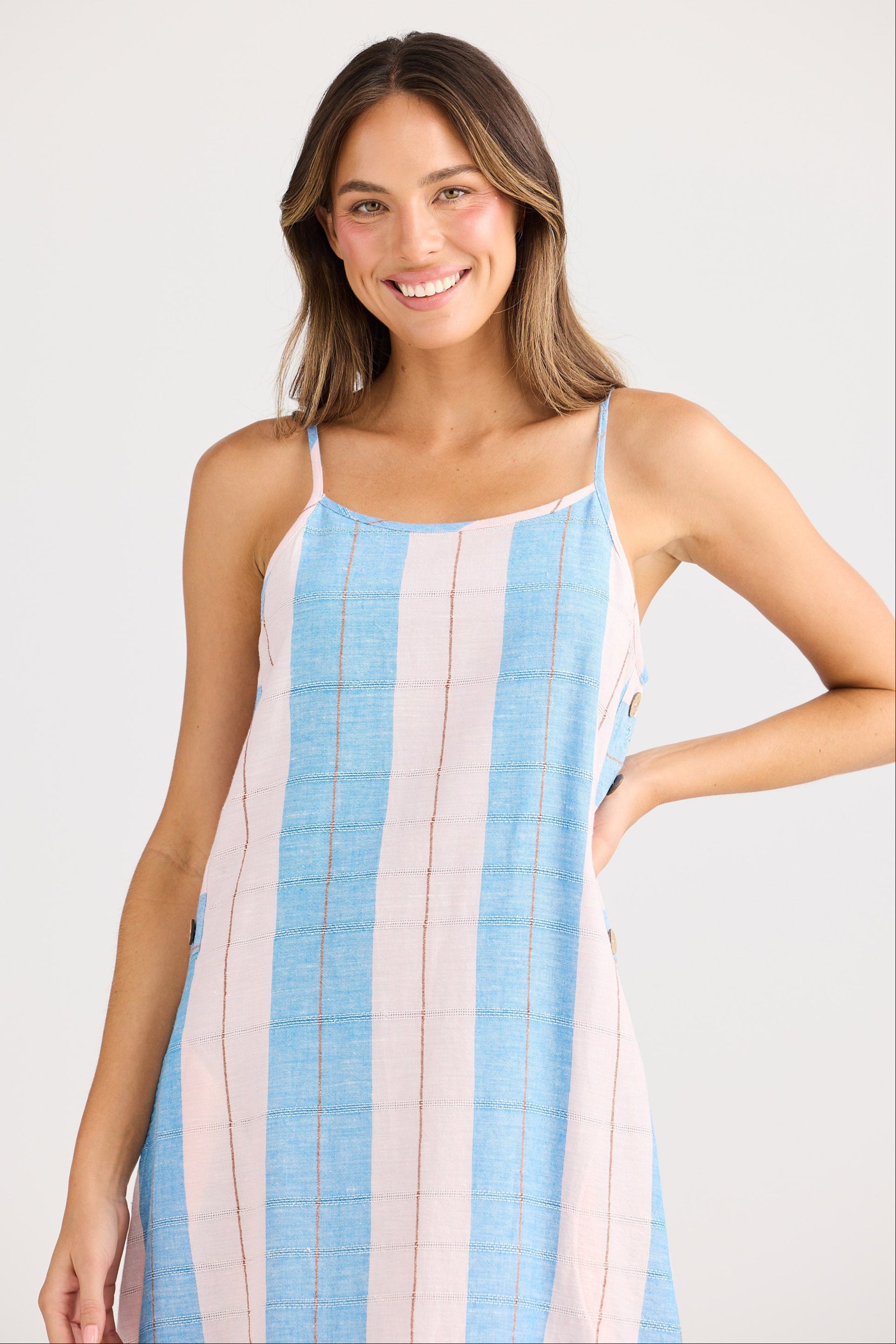 Woman wearing a striped dress with a plain background