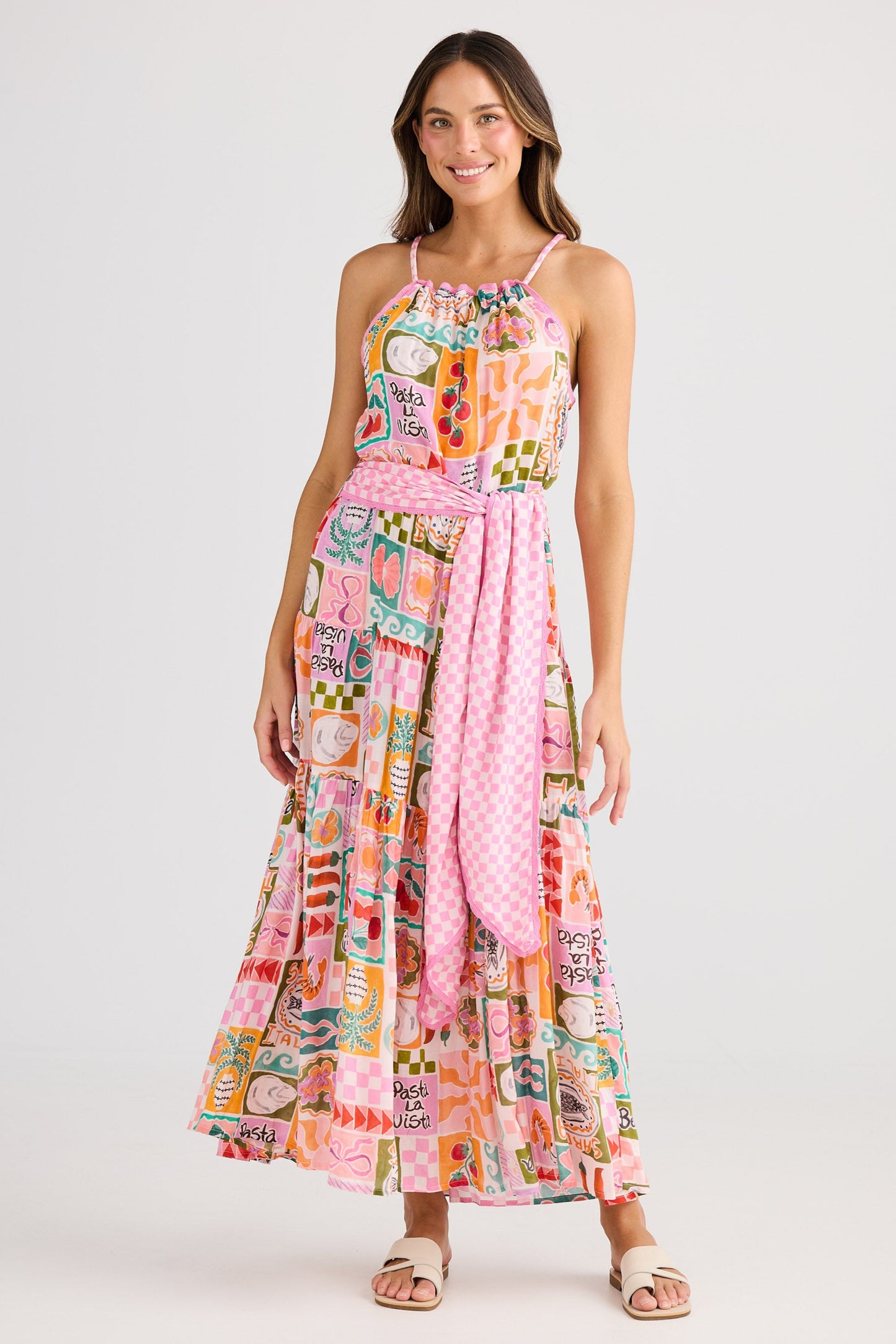 Woman wearing a colorful patterned dress on a white background