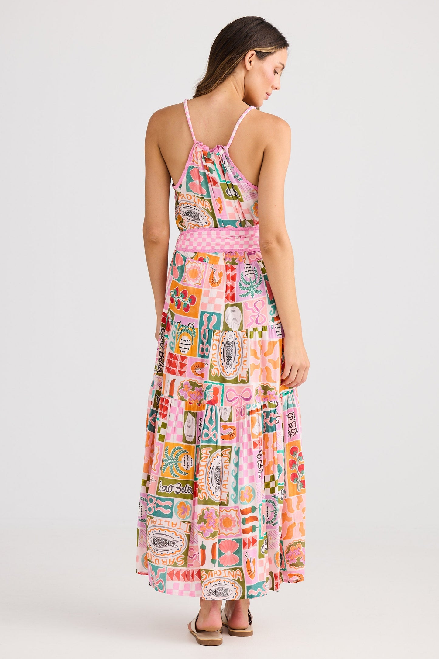 Woman wearing a colorful patterned dress on a white background