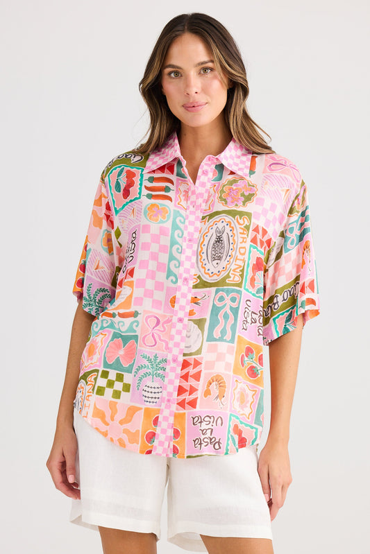 Woman wearing a colorful patterned shirt on a white background