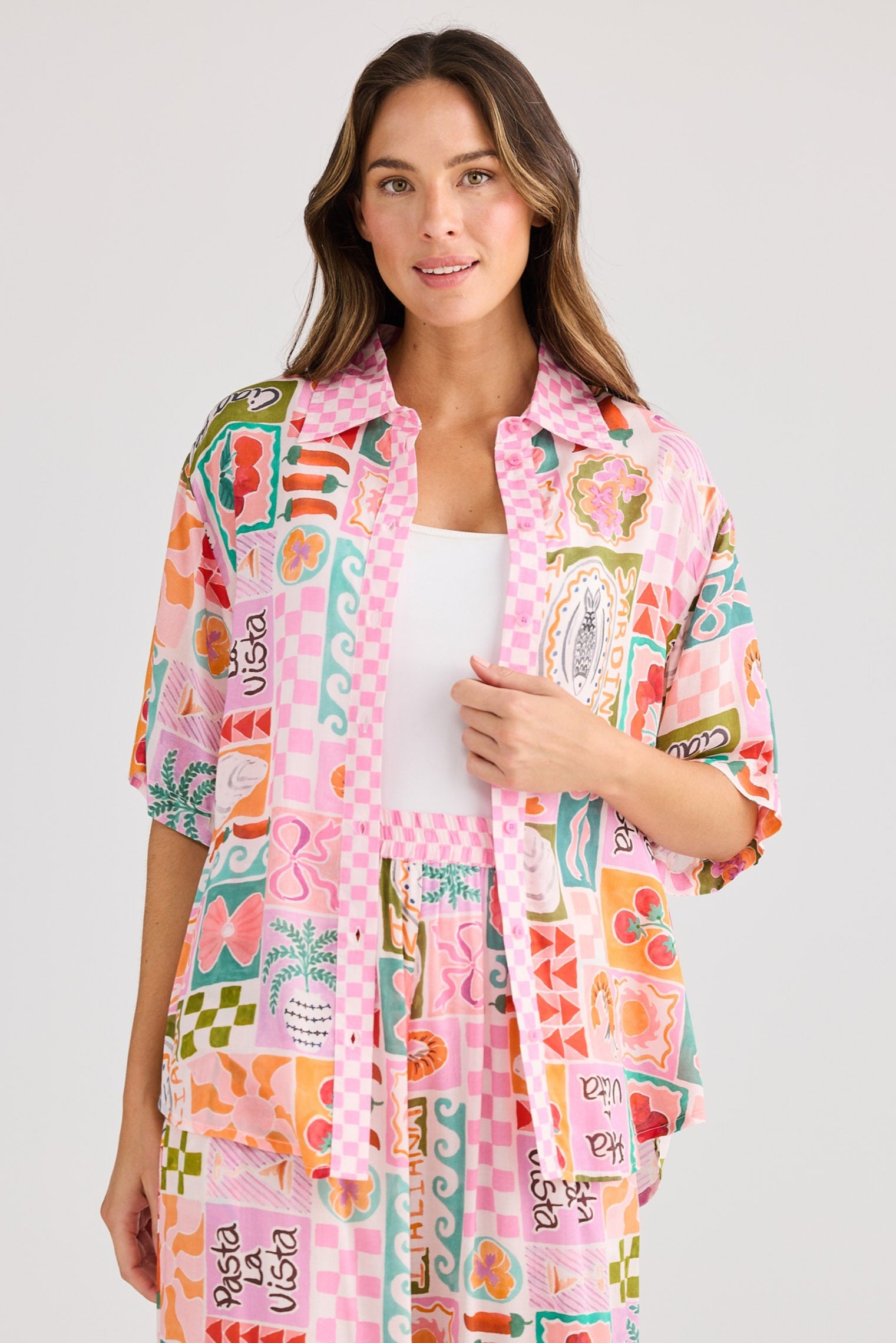 Woman wearing a colorful patterned kimono-style robe on a white background