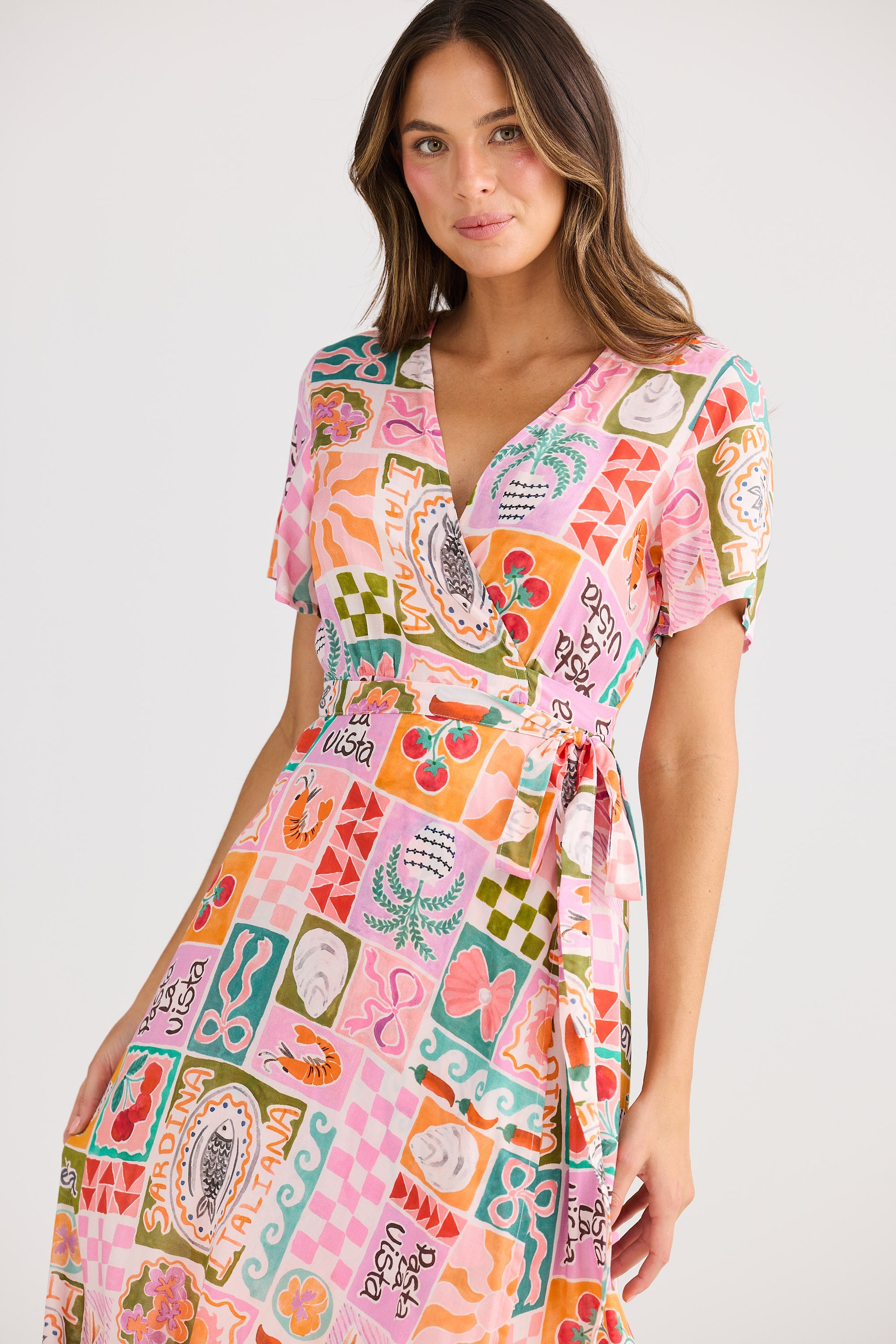 Woman wearing a colorful patterned dress on a white background