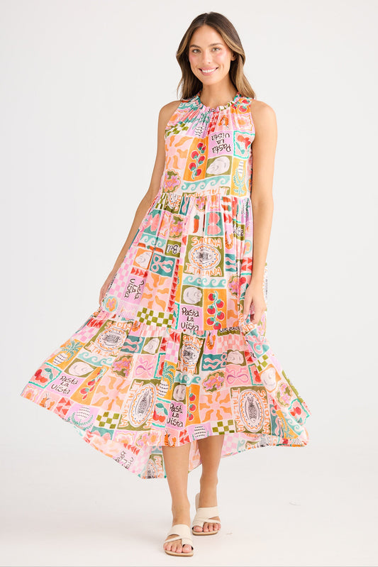 Woman wearing a colorful patterned dress on a white background