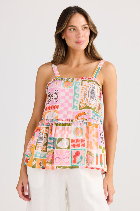 Woman wearing a colorful patterned top on a white background