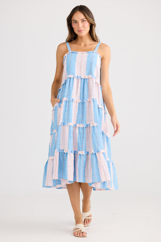 Woman wearing a blue and white striped dress on a white background