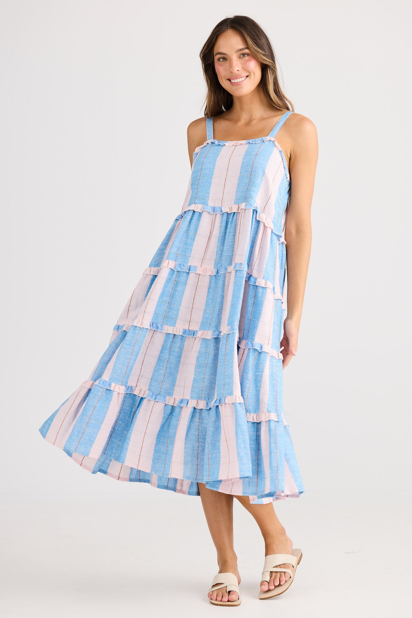 Woman wearing a blue and white striped dress on a white background