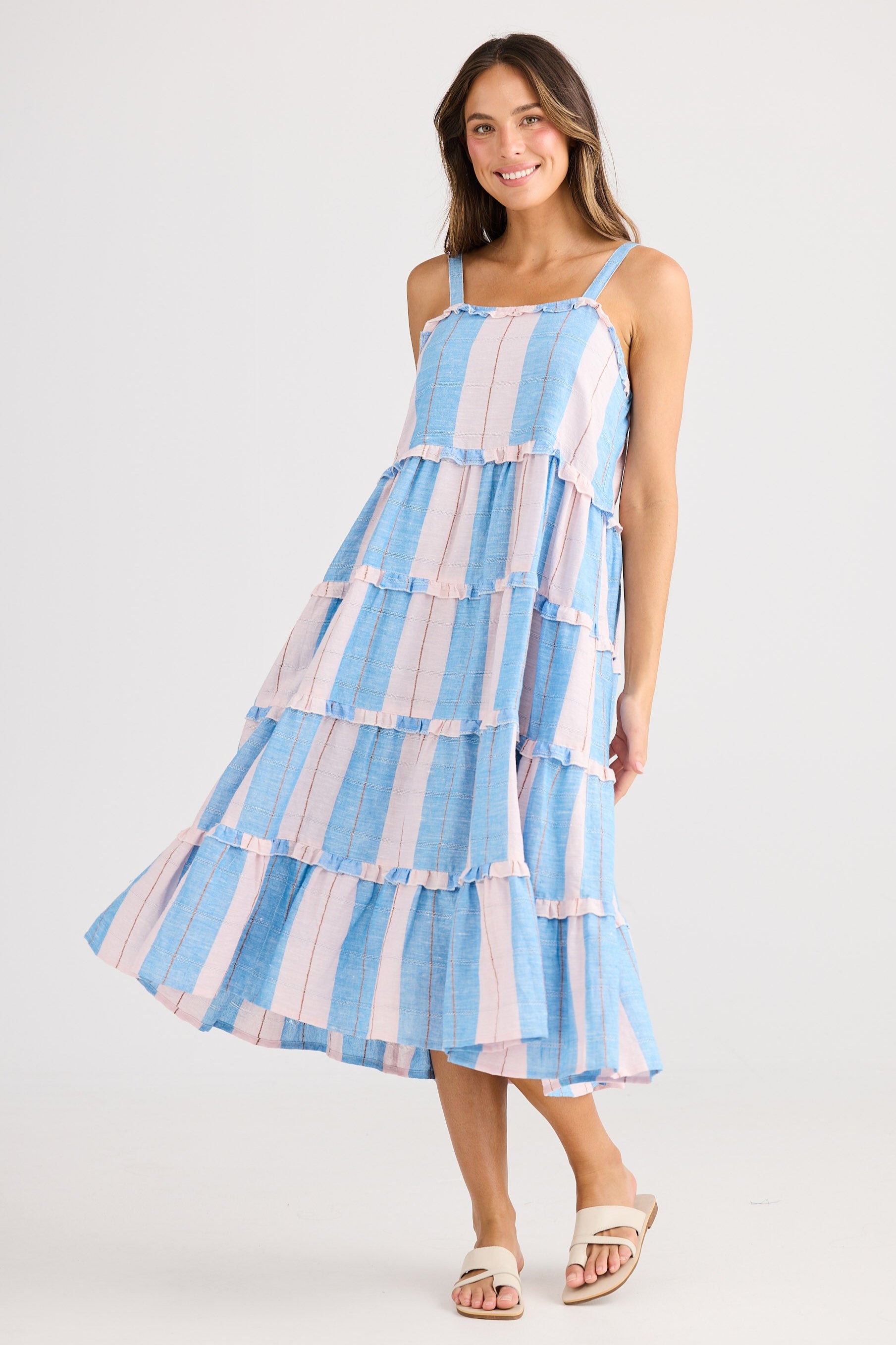 Woman wearing a blue and white striped dress on a white background