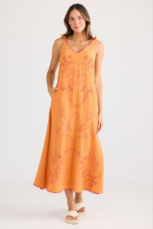 Woman wearing an orange dress with a white background