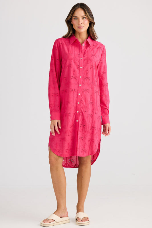 Woman wearing a pink dress against a white background