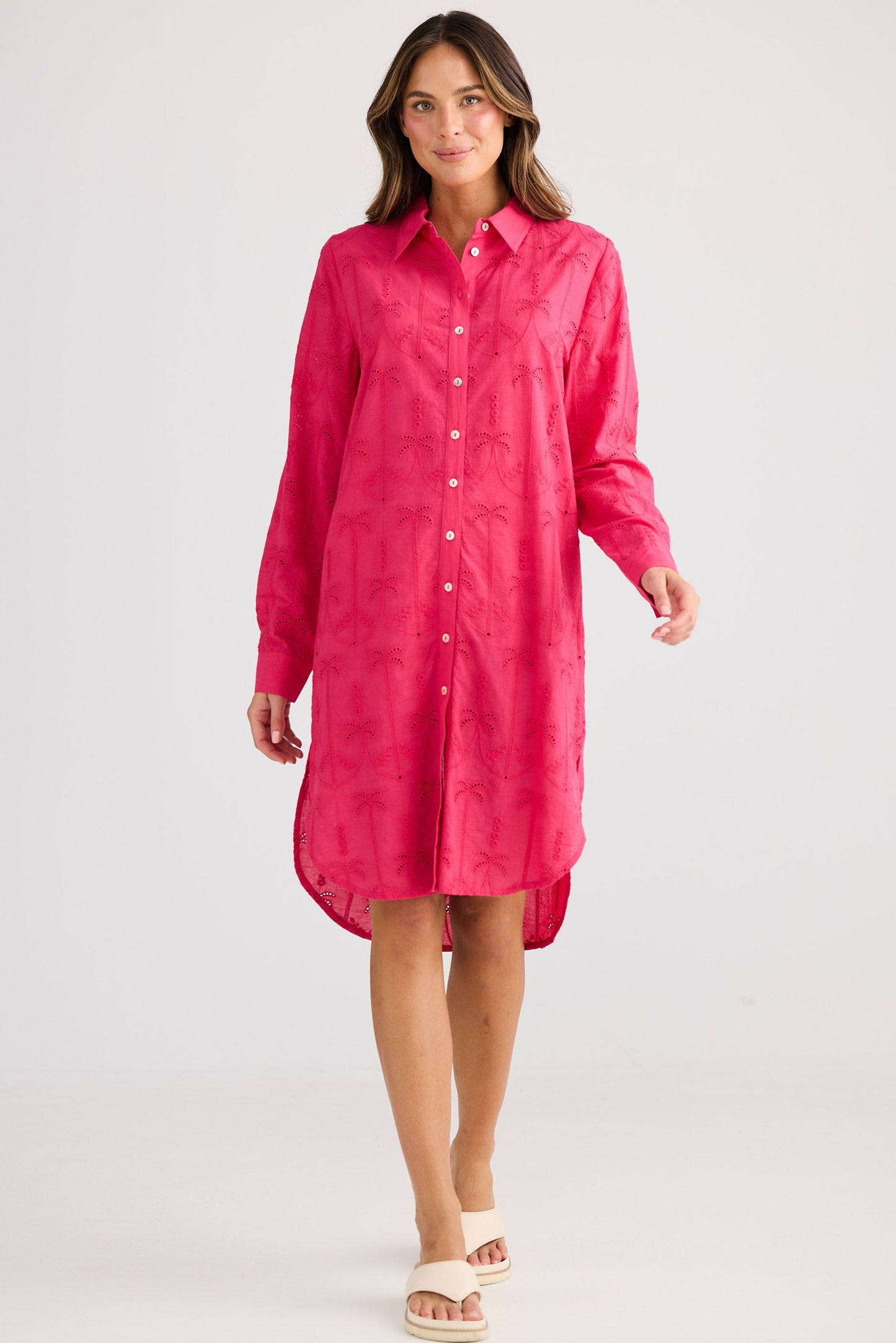 Woman wearing a pink dress against a white background