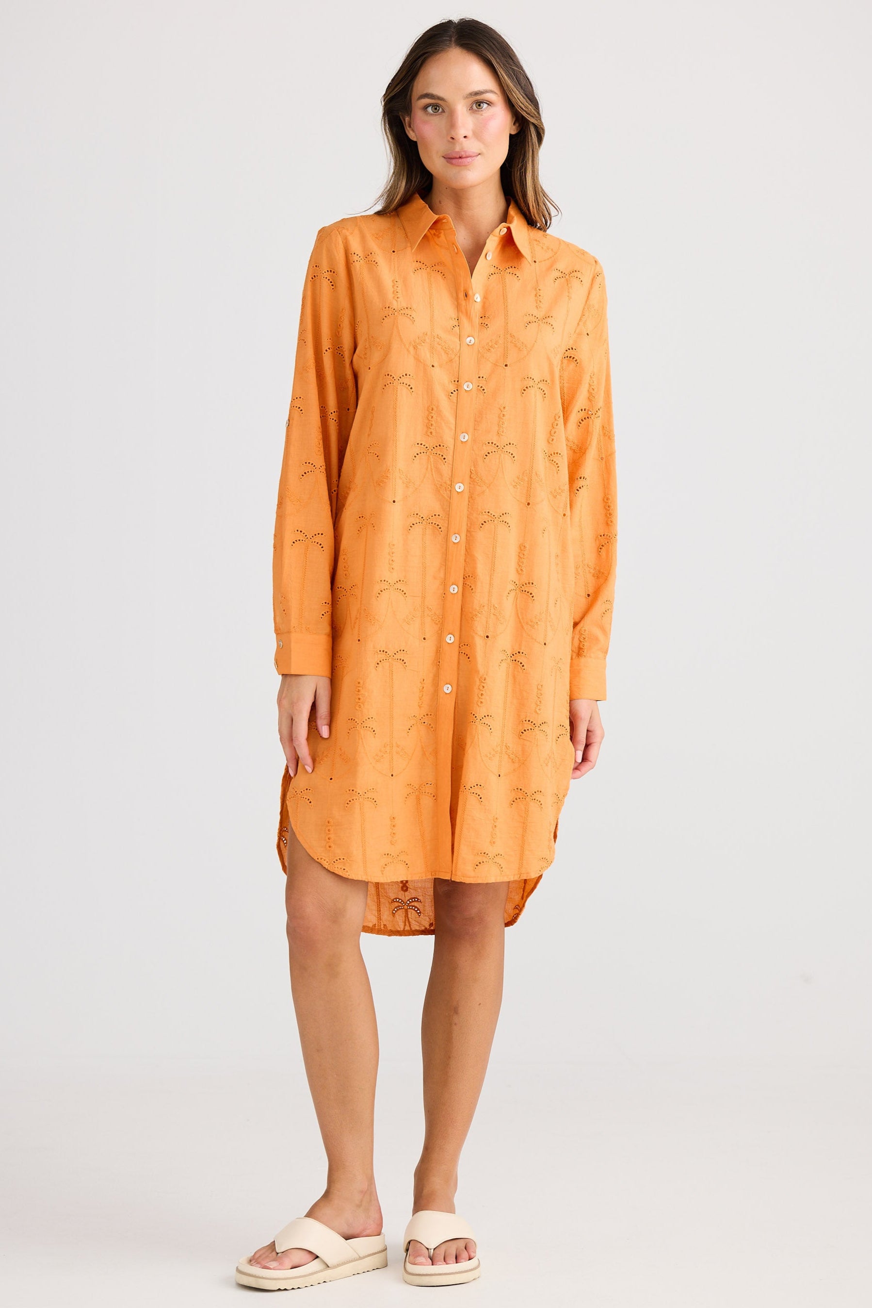 Woman wearing an orange dress on a white background