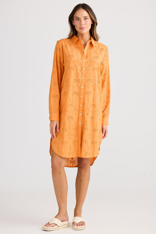 Woman wearing an orange dress on a white background