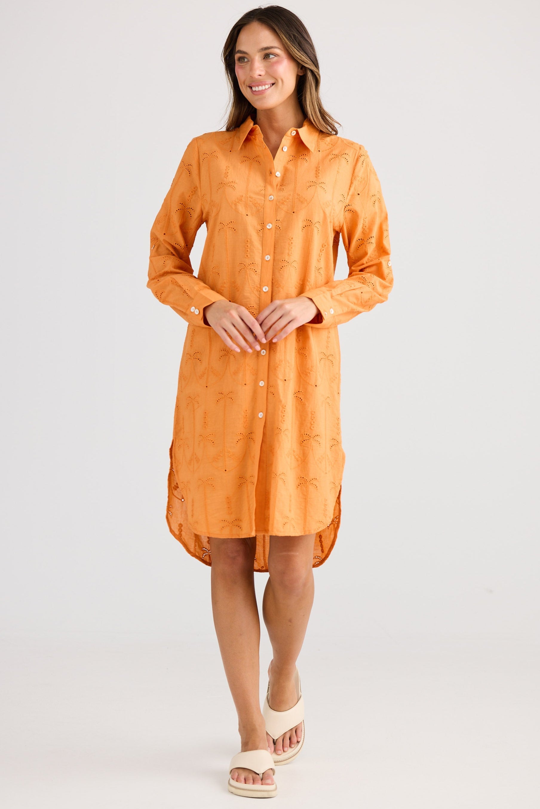 Woman wearing an orange dress on a white background