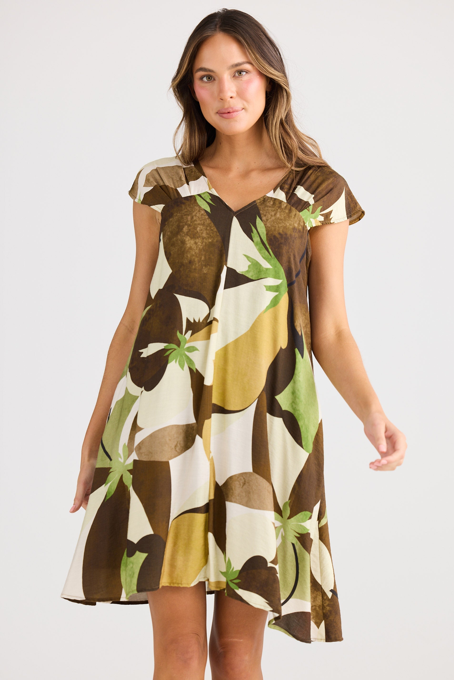 Woman wearing a patterned dress on a plain background