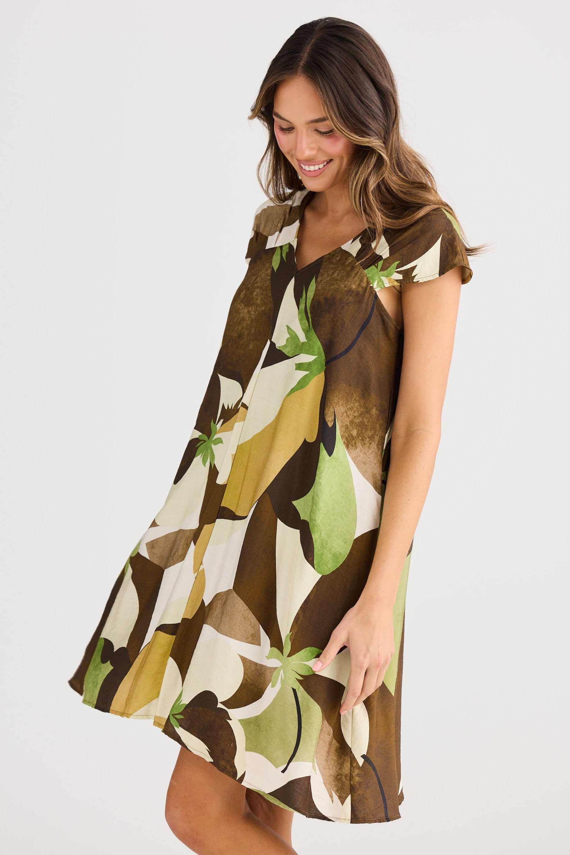 Woman wearing a patterned dress on a white background