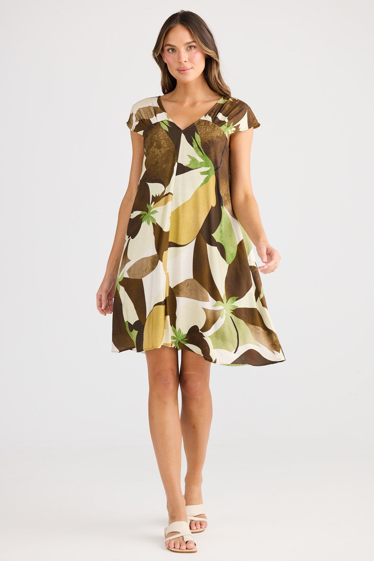 Woman wearing a patterned dress on a white background