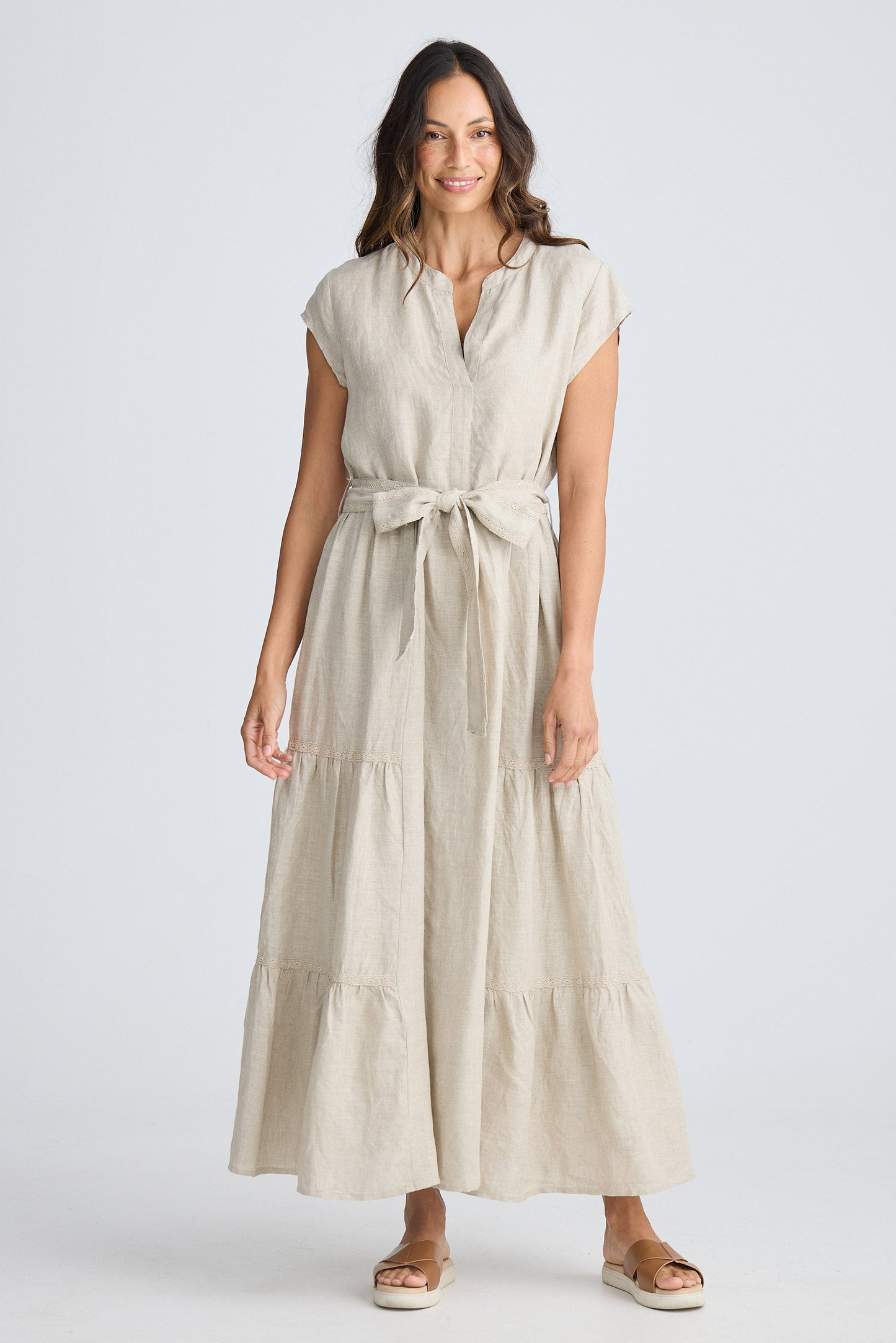 Woman wearing a beige dress on a white background