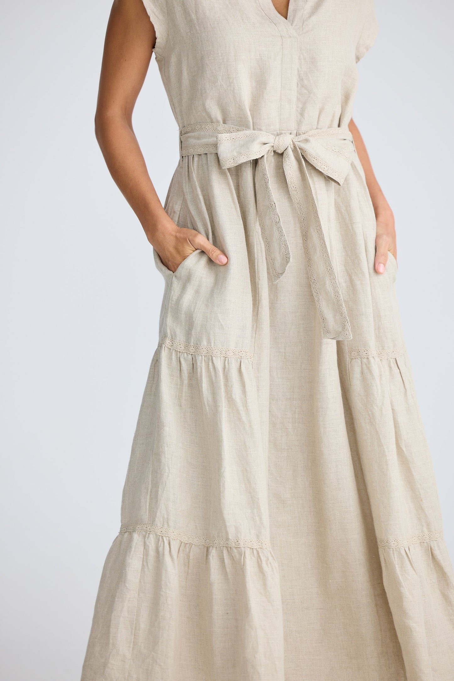 Beige dress with a belt on a plain background