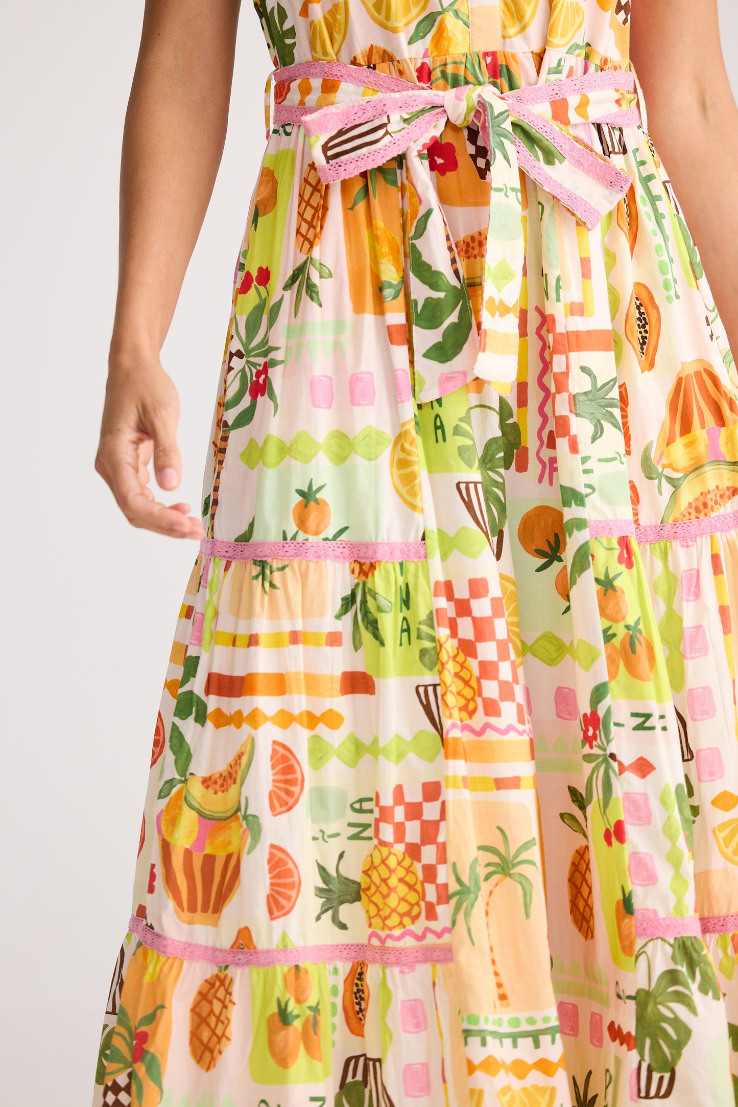 Colorful apron with fruit and patterned design on a plain background