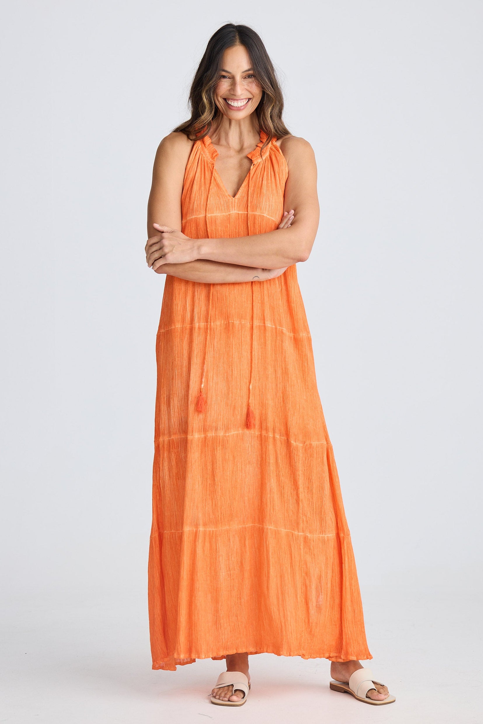 Woman wearing an orange dress on a white background