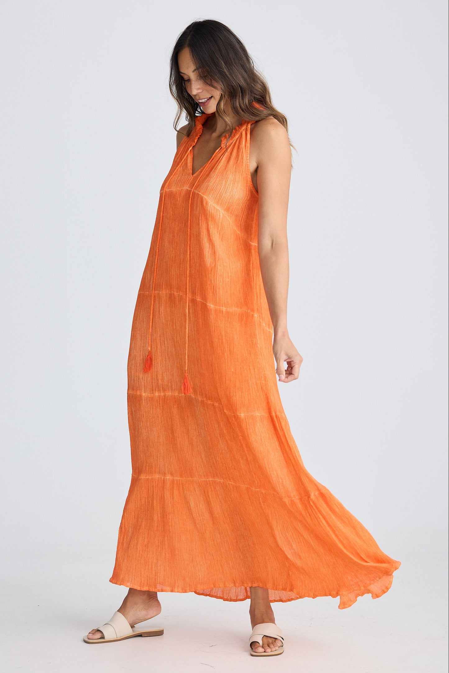 Woman wearing an orange dress on a white background