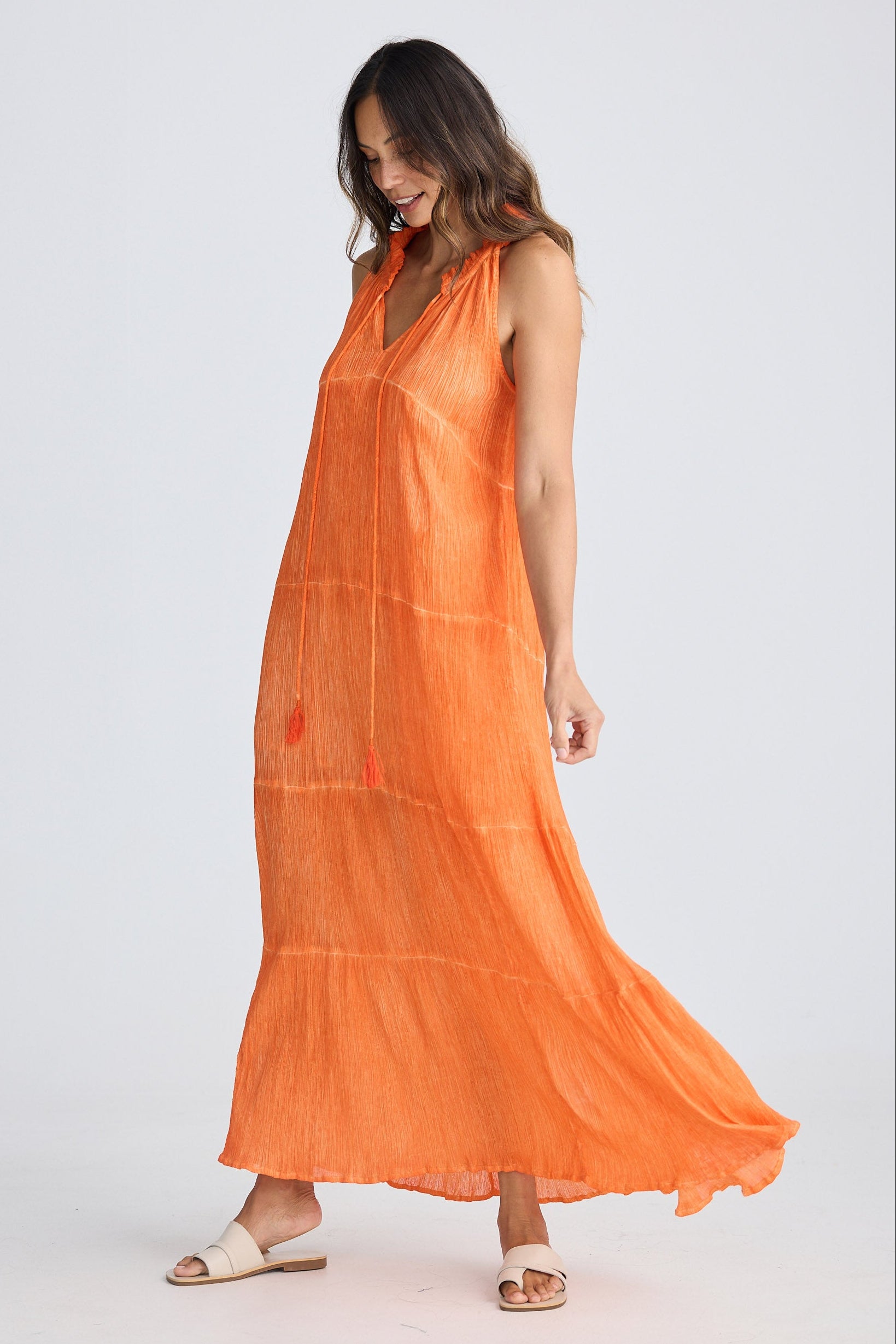 Woman wearing an orange dress on a white background