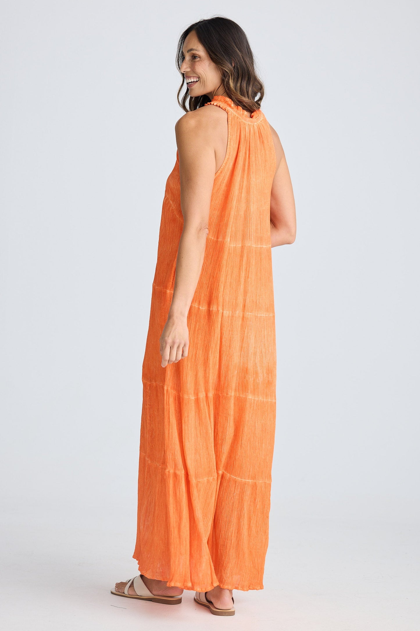Woman wearing an orange dress on a white background
