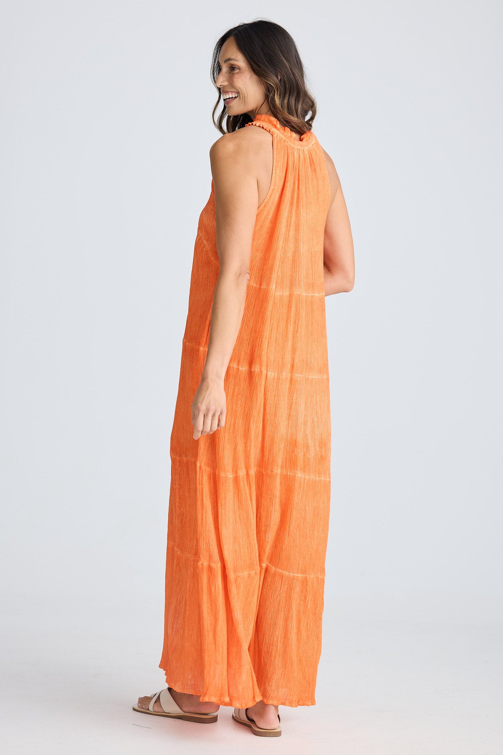 Woman wearing an orange dress on a white background