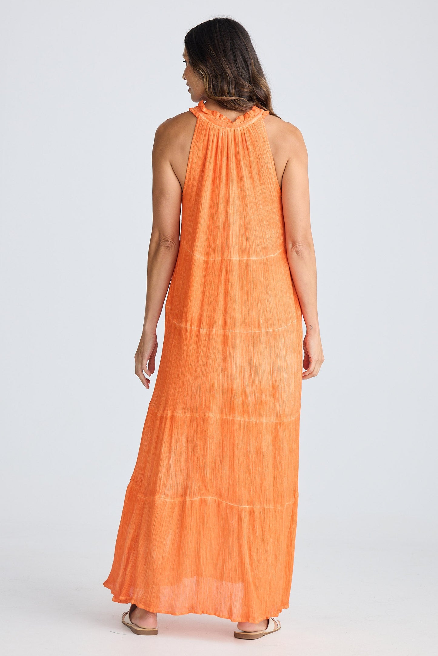 Woman wearing an orange dress on a white background