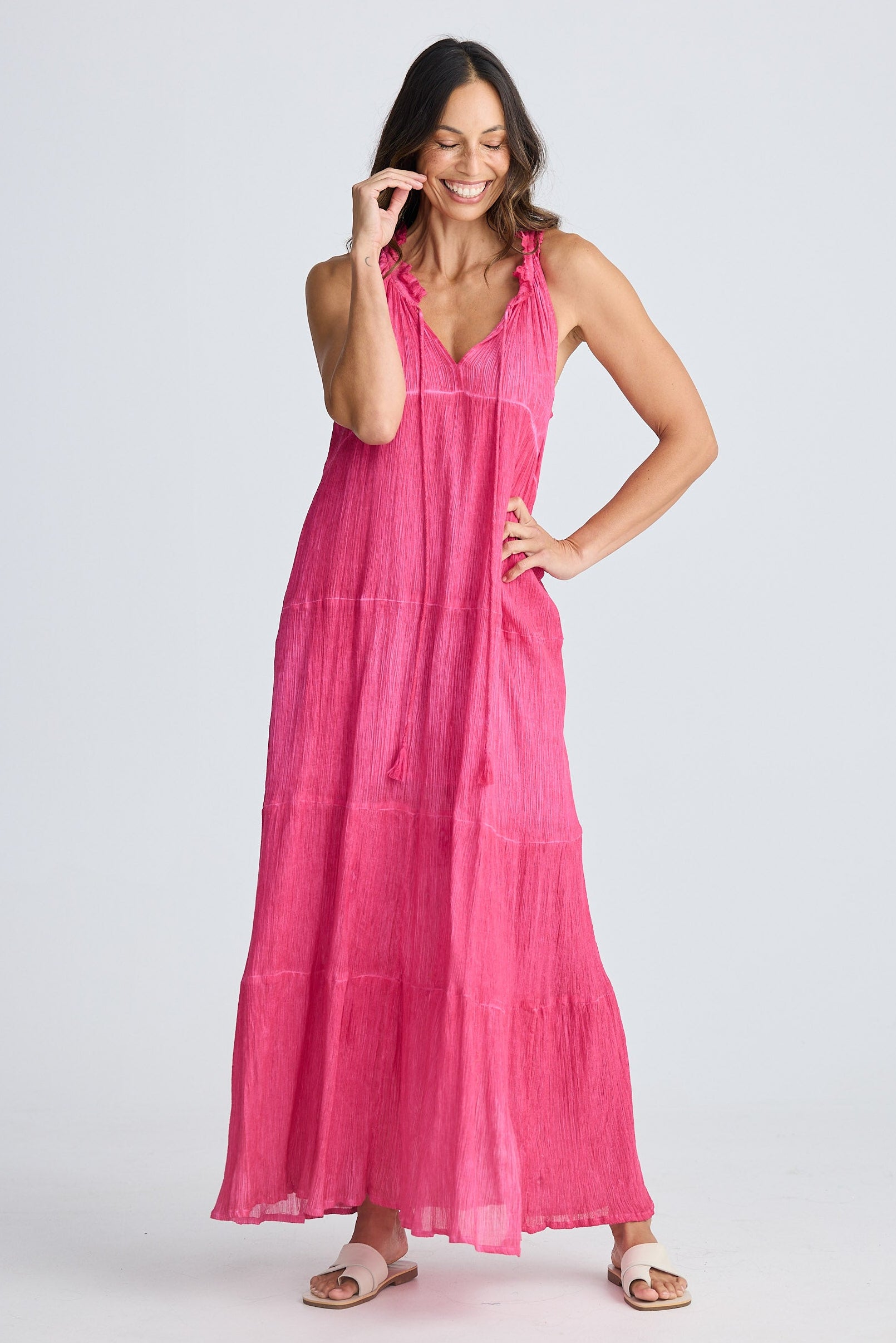 Woman wearing a pink dress on a white background