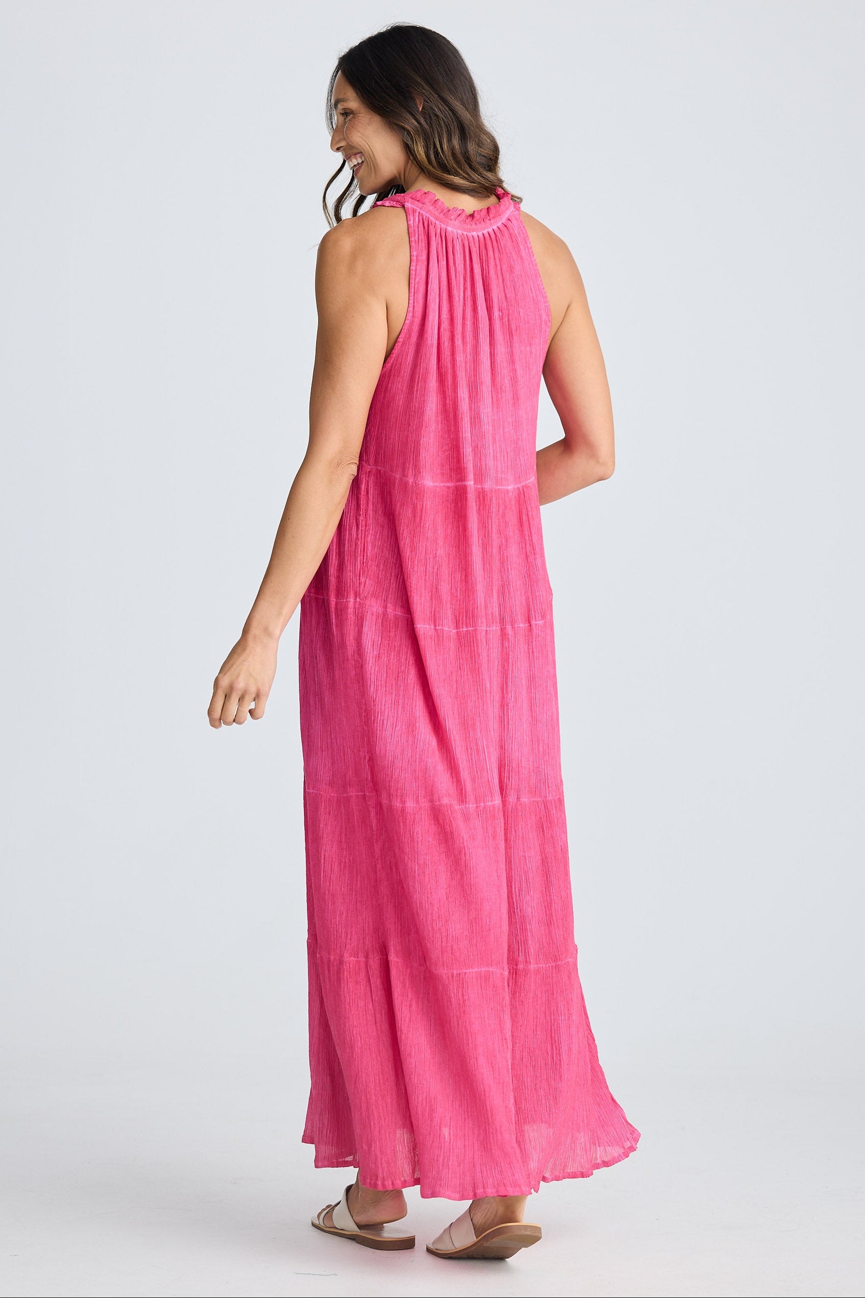 Woman wearing a pink dress on a white background