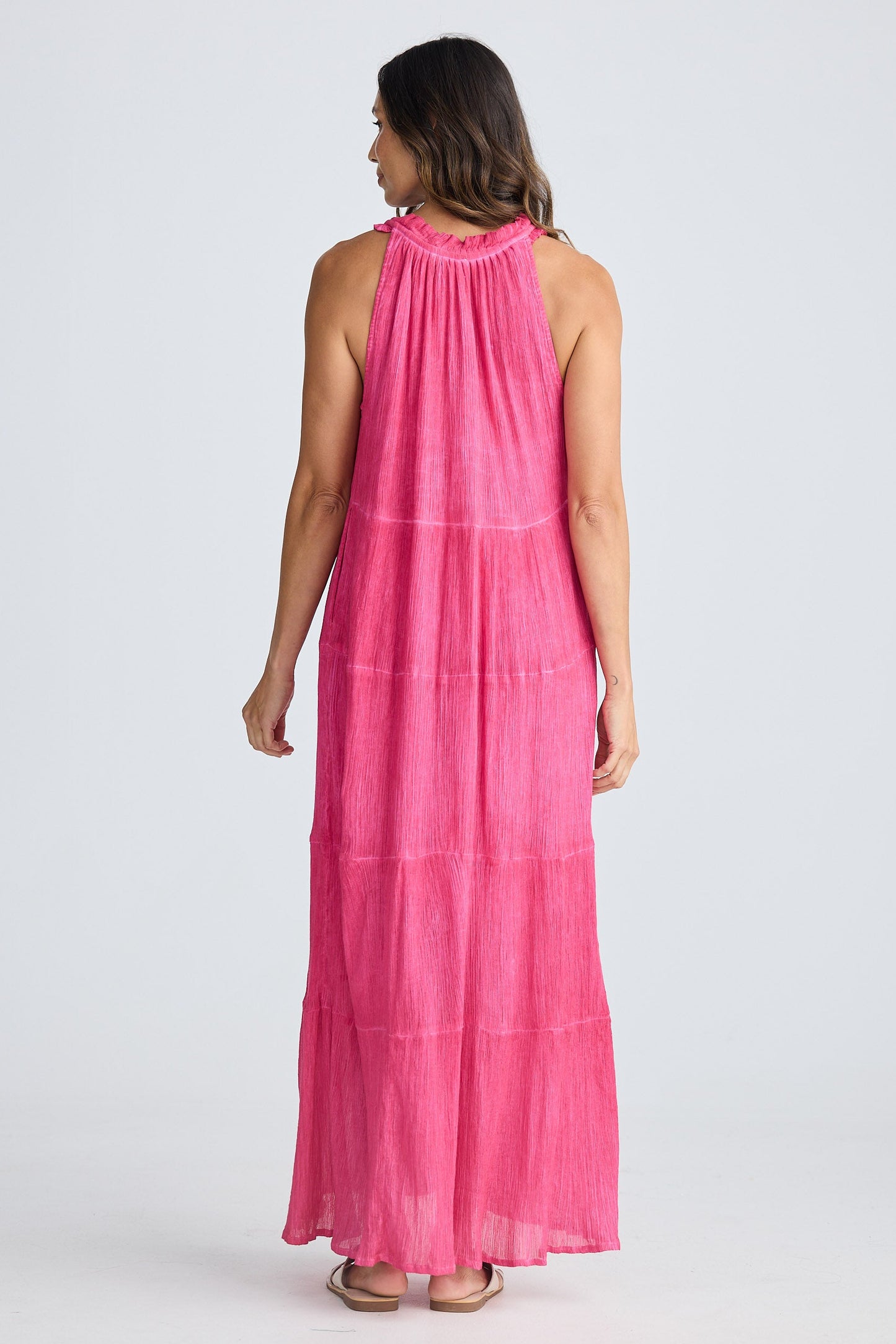 Woman wearing a pink dress on a white background