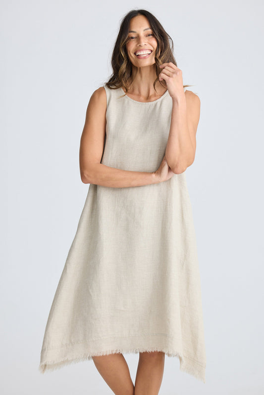 Woman wearing a beige sleeveless dress on a white background