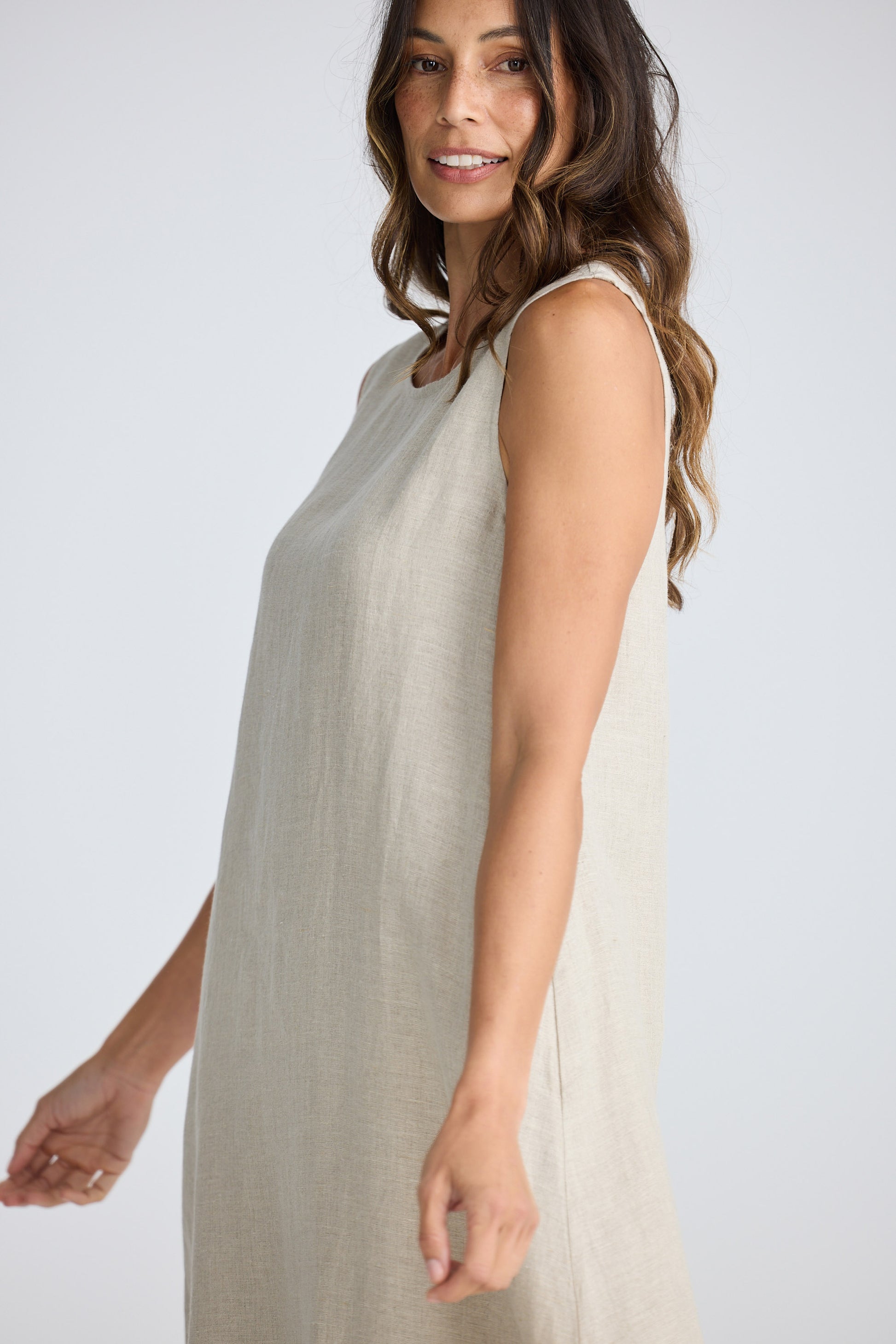 Woman wearing a sleeveless dress on a white background
