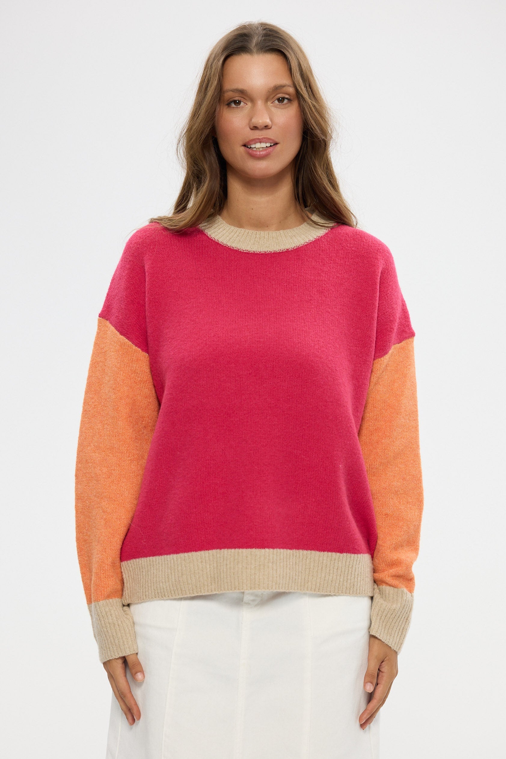 Woman wearing a colorful sweater with a white background