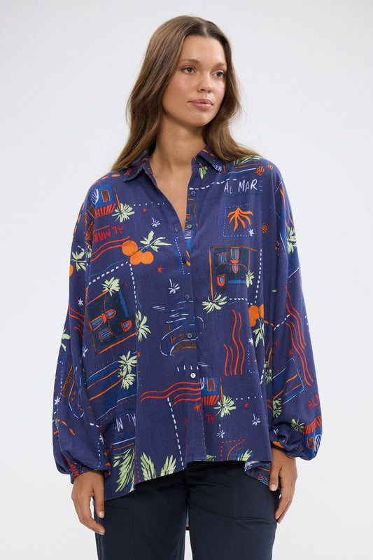 Woman wearing a colorful patterned shirt on a white background