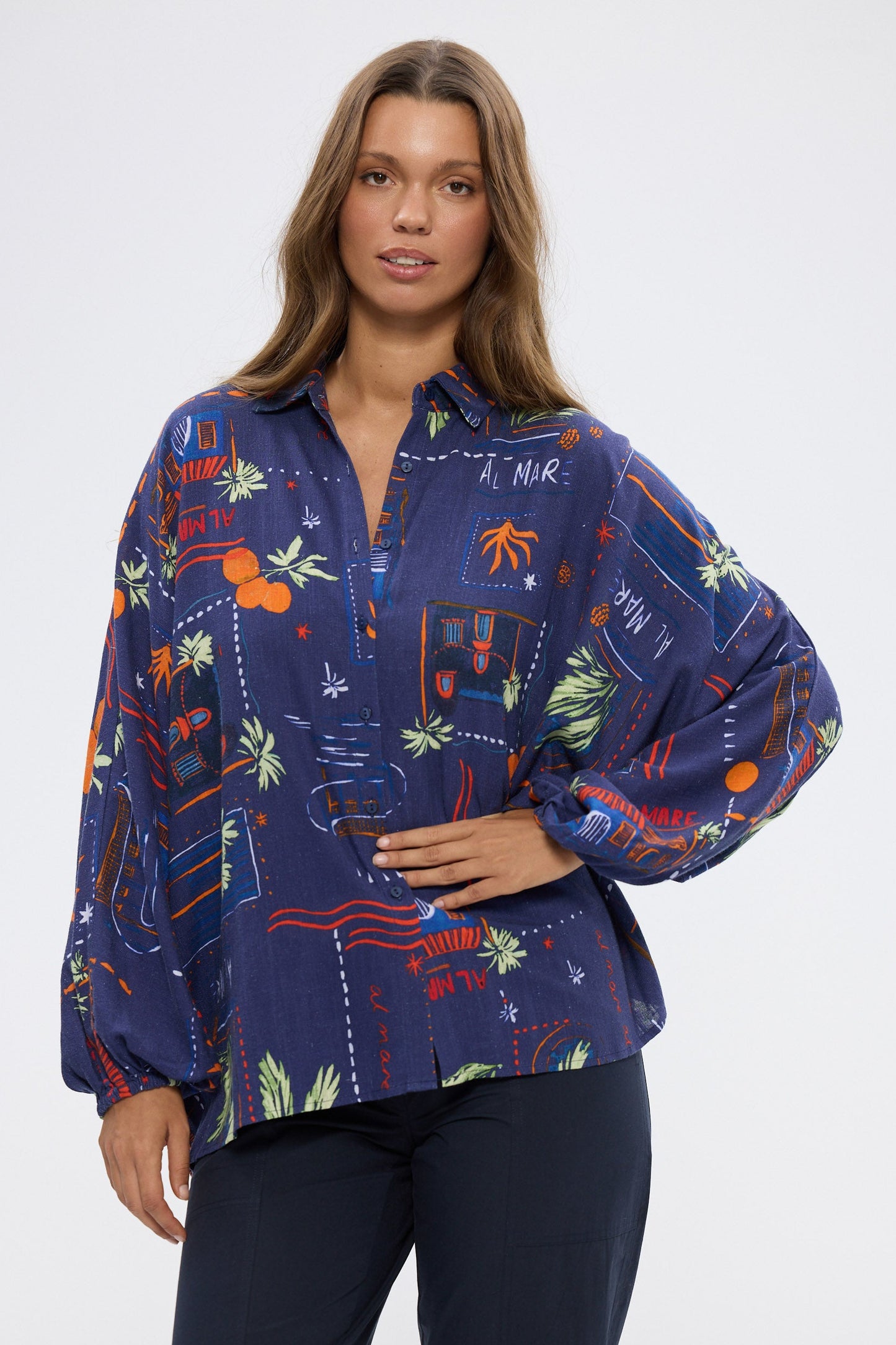 Woman wearing a colorful patterned shirt on a white background