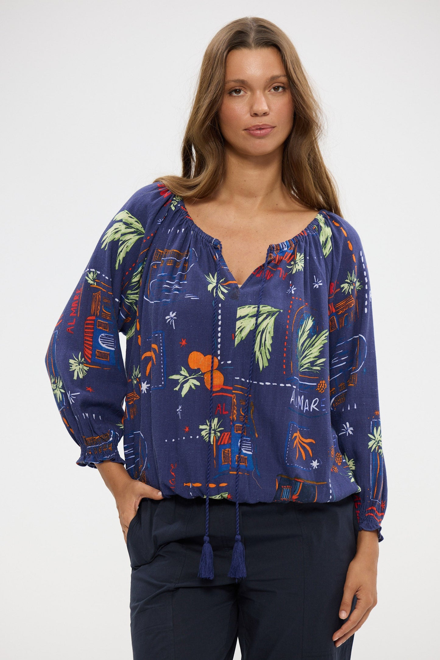 Woman wearing a blue floral blouse with a white background