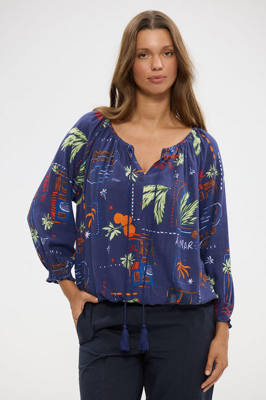 Woman wearing a blue floral blouse with a white background