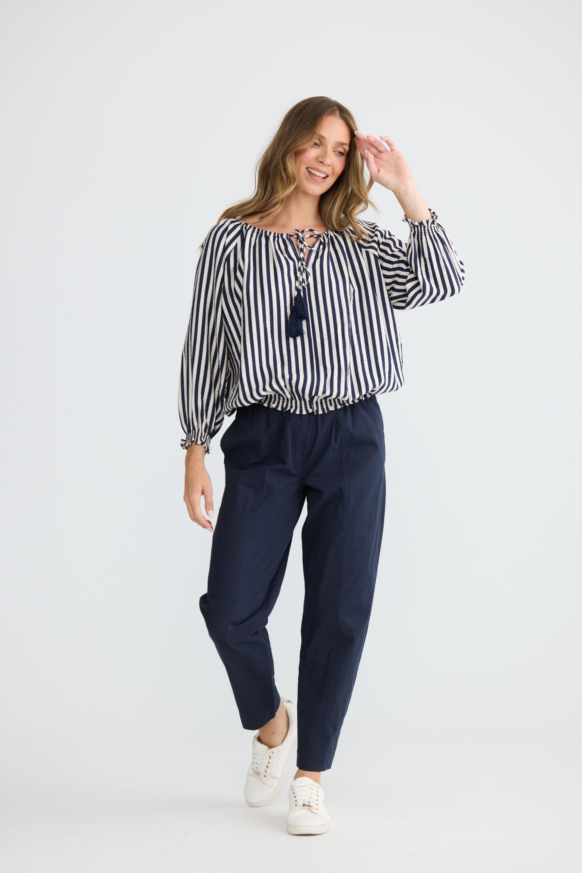 Model wearing Seaside Top Navy and White Stripe with neck ties and shirred cuffs, detail view on white background