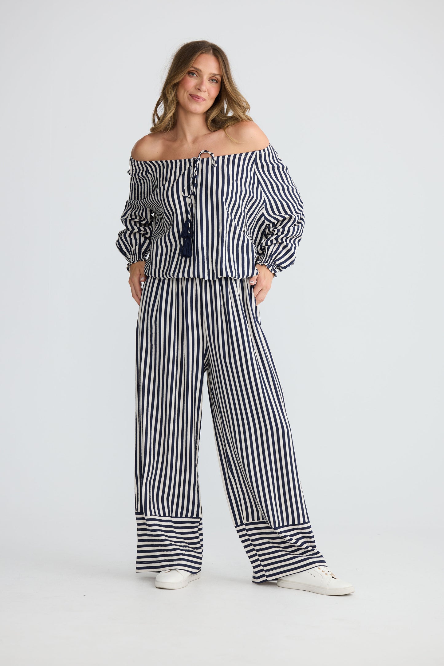 Model wearing Seaside Top Navy and White Stripe with neck ties and shirred cuffs, front view on white background