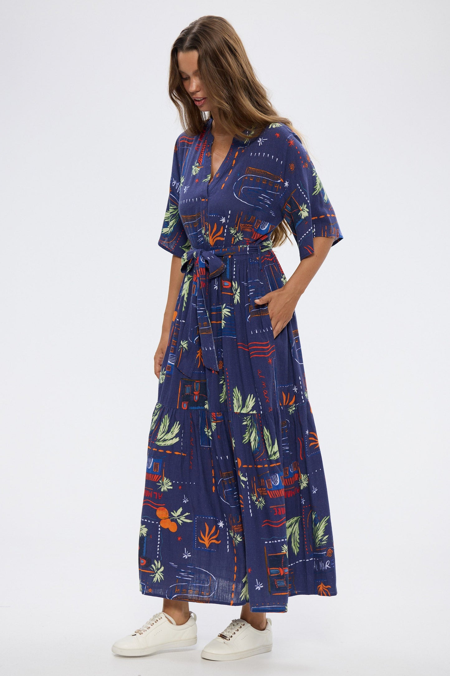 Woman wearing a blue floral dress on a white background
