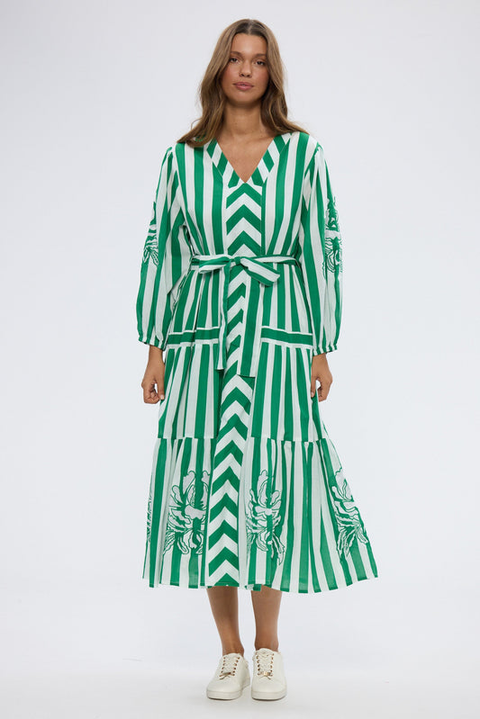 Woman wearing a green and white striped dress on a white background